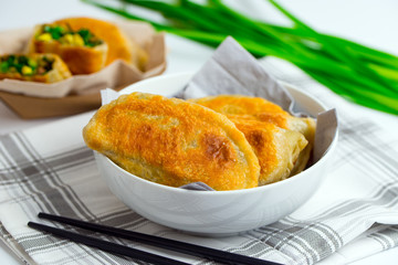 Chinese chives boxes - homemade pan fried chive dumplings in white bowl