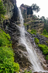waterfall flowing down a steep cliff in the mountains