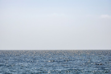 Sun glare on sea, horizon sky, wallpaper. Peaceful seascape, background.
