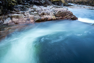 long exposure shot of the waterfalls in glen etive near loch etive and the entrance to glencoe and rannoch moor in the argyll region of the highlands of scotland during winter
