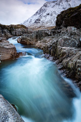 Fototapeta na wymiar long exposure shot of the waterfalls in glen etive near loch etive and the entrance to glencoe and rannoch moor in the argyll region of the highlands of scotland during winter