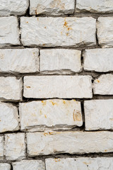 Texture of old sandstone brick wall. Foundation of an ancient village house