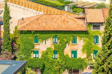 Fototapeta na wymiar Top view to red roofs in Torbole old city, Italy.