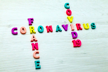 Coronavirus COVID-19 in FRANCE - Rainbow colored wood letters on grey wooden background