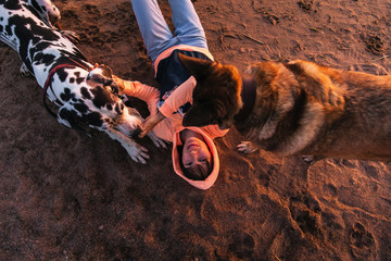 Thoughtful female owner with dog on coastline
