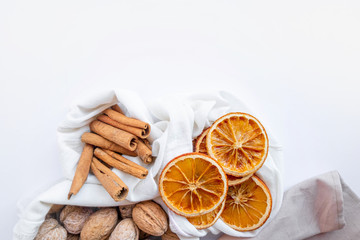 Eco bag with walnut, dry orange and cinnamon on white background