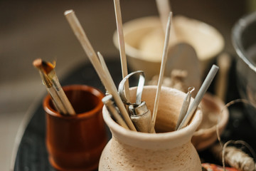 Close-up of pottery tools at ceramic workshop. Art concept. 