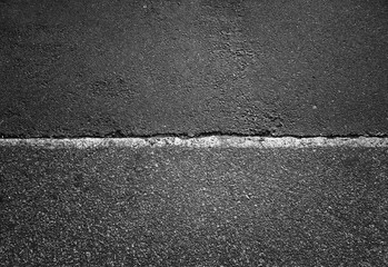 Horizontal dividing line on asphalt road