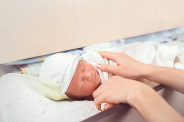 Obraz na płótnie Canvas Adorable newborn baby sleeping in shelf in the dresser