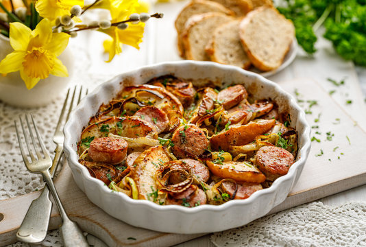 Sausage casserole with the addition of onion leeks and apple particles served in dish