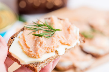 sandwich.made of bread and spreads with caviar decorated with microgrin.Festive snack