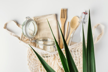 Zero waste, plastic-free and eco-friendly lifestyle. Cotton mesh bag, glass bottle, jar and bamboo cutlery for package free shopping or picnic