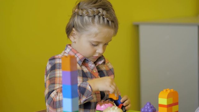 Children in the classroom make figures with teacher. Modern technology concept