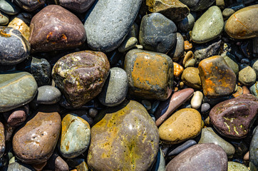 Pebbles on the sea beach. Background and texture. Travel and adventure.