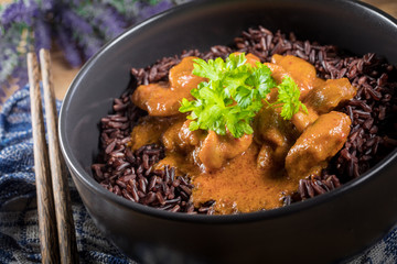 Thai red curry with chicken and black rice.