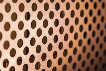 Close-up of a metal grill with round holes