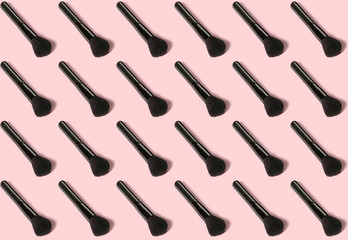 Many makeup brushes on color background