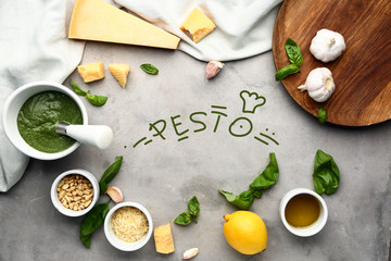 Fototapeta na wymiar Ingredients for pesto sauce on grey background