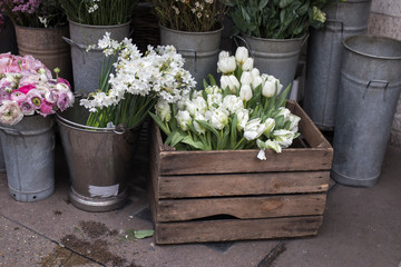 variety of colors near the Liberty store in London. Large bouquets in tin vases. Ranunculus and tulips in wooden box