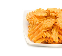 Plate with tasty potato chips on white background
