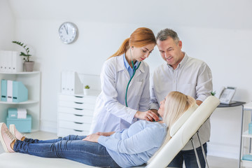 Mature couple visiting doctor in clinic