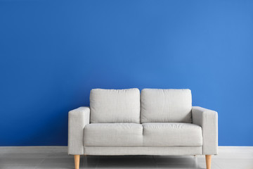 Modern sofa near color wall