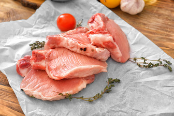 Raw pork meat with herbs on table