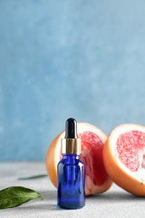 Bottle of grapefruit essential oil on table