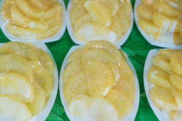 Peeled and packed pomelo on street market.