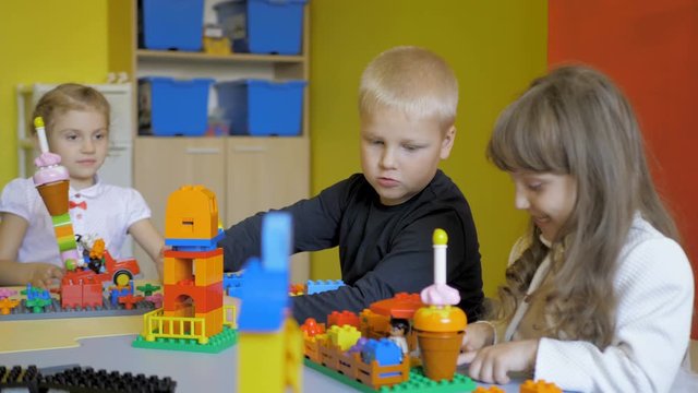 Kids creating robots with teacher. Early development, innovation, modern technology concept