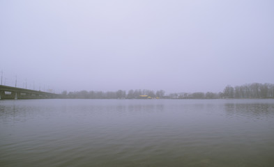 Wide view of the river dark in the fog in nature in the morning