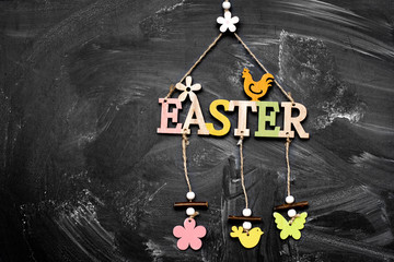 Wooden inscription light Easter on a black slate with chalk stains. place for text. mocap