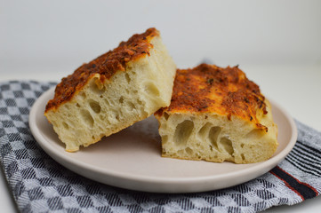 Traditional italian bread, focaccia siciliana with tomatoes, oregano and sardines, sicilian food, close up