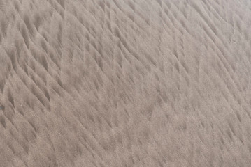 Fototapeta na wymiar Natural background, beach floor, sand texture with water lines