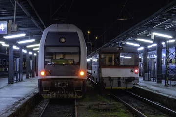 Naklejka premium Modern train next to old train at the train station