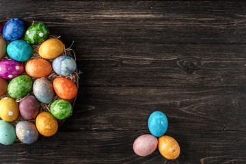 Different easter eggs on wooden background