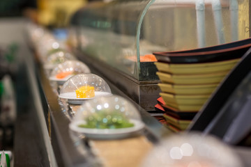 Japan restaurant sushi conveyor or belt buffet. belt sushi in japan restaurant with blurred background.