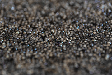 Macro background of black surgeon or beluga caviar