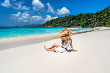 Women sitting on Beach Anse Petite,  Seychelles, 