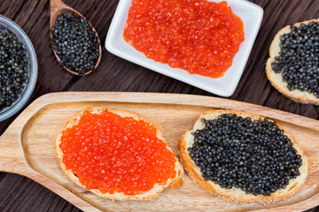 Sandwiches with black sturgeon and red salmon caviar close up