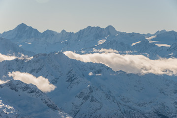 Fototapeta premium Beautiful panoramic view of snow-capped mountains in the Swiss Alps.