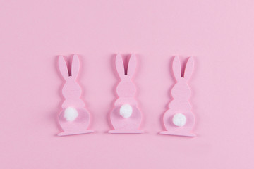 Pink Easter bunnies on pink background, easter greeting card, top view