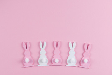 Easter bunnies on pink background, easter greeting card, top view with copy space