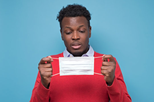 African American Man Using Medical Mask Is Shocked With Coronavirus