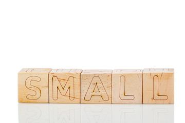 Wooden cubes with letters small on a white background