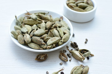 Dry cardamom seed (Elettaria cardamomum) displayed in containers