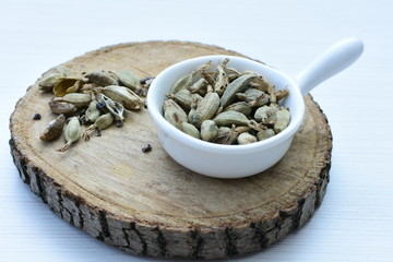 Dry cardamom seed (Elettaria cardamomum) displayed in containers