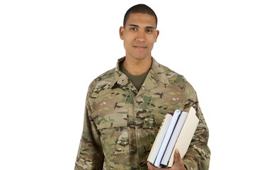 Young soldier holding school books, getting ready to go to college using his GI Bill benefits.