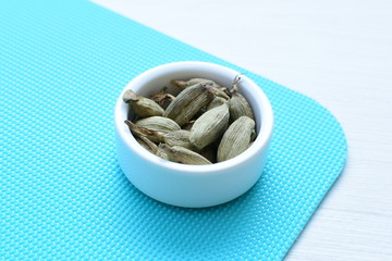 Dry cardamom seed (Elettaria cardamomum) displayed in containers