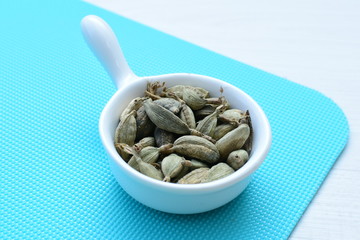 Dry cardamom seed (Elettaria cardamomum) displayed in containers